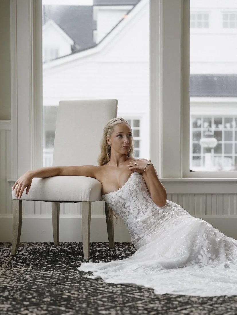 blonde bride sitting on the floor in her wedding gown at a clubhouse