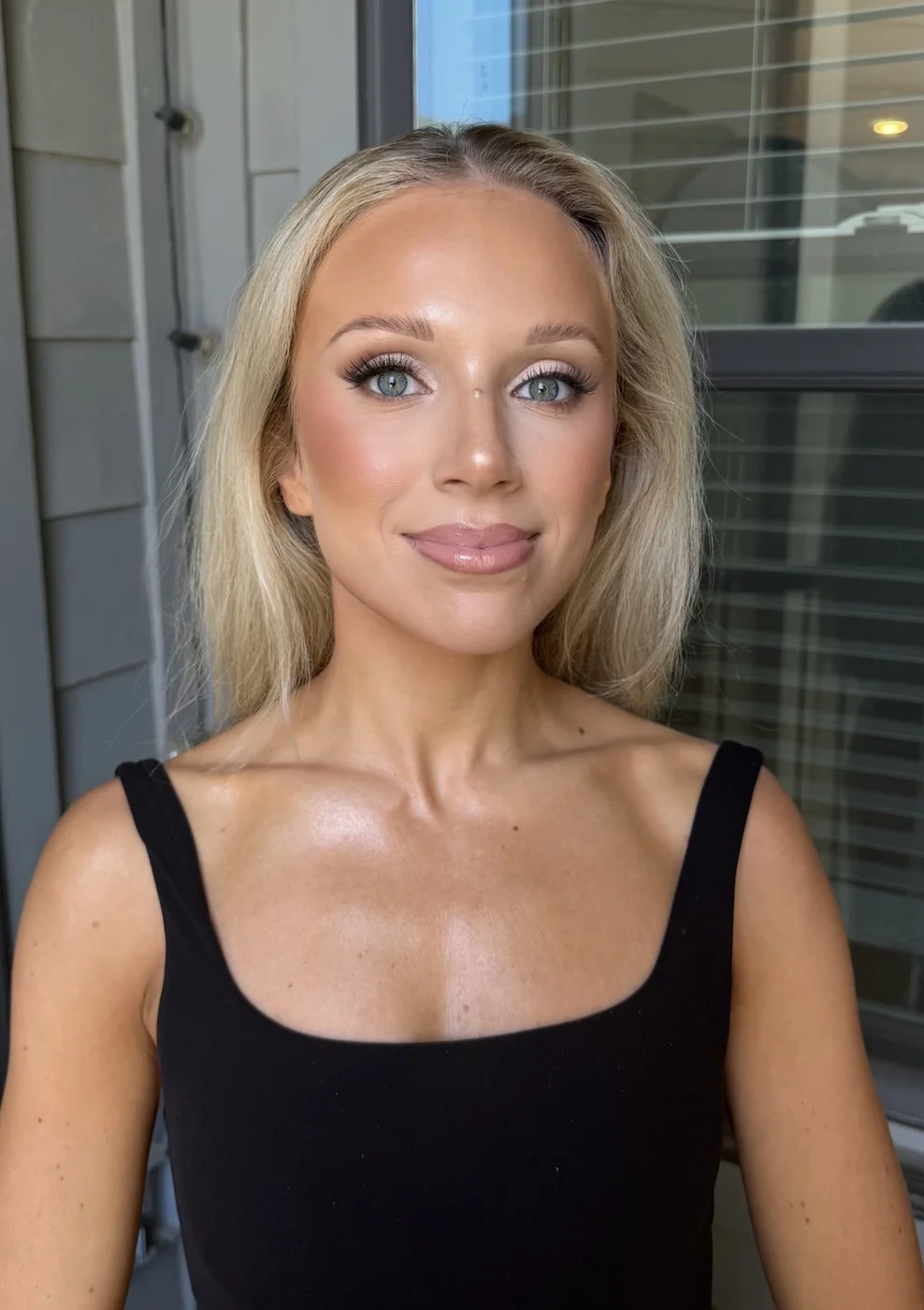 soft glam wedding makeup on a bride with blonde hair and blue eyes