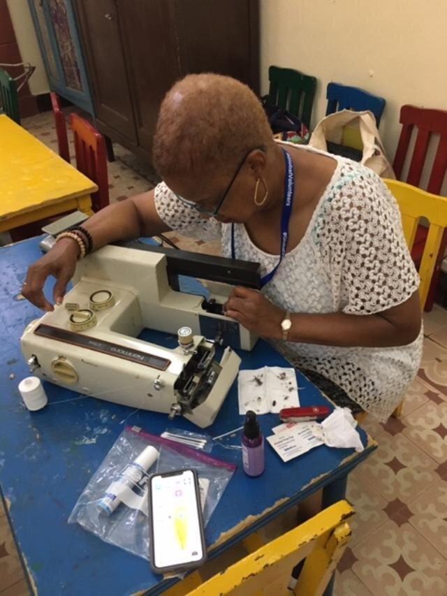 LaVerne Lewis, Team Leader repairs sewing machines in the Sewing Circle Program at Presbyterian Church in Cuba.JPG