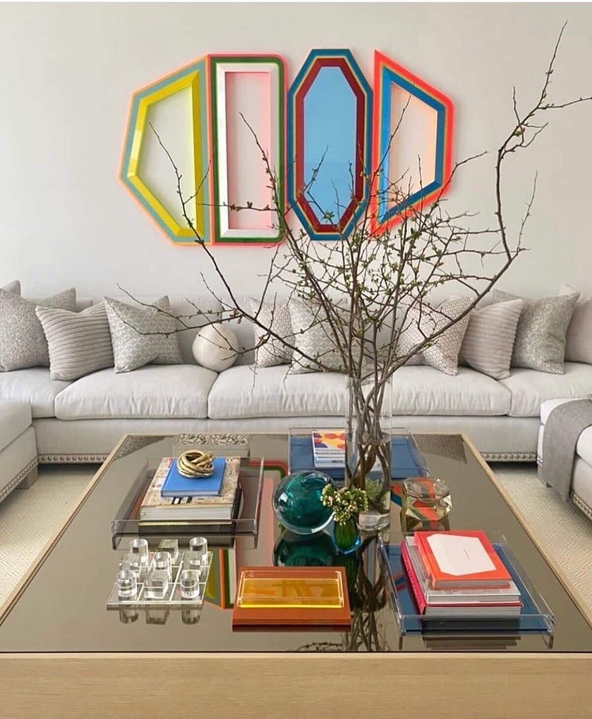 The abstract art by Beverly Fishman heightens the room with a colourful combination of geometric shapes echoing the coffee table layout as designed by Aman &amp; Meeks. ⁠
Via @amanmeeks⁠
#AmanMeeks #BeverlyFishman #GeometricArt #AbstractArt #CoffeeTa