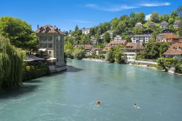 The river in Bern with 2 swimmers in