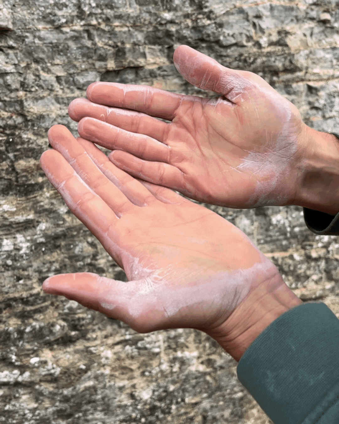 GIF of hands with liquid chalk drying at an outdoor crag.