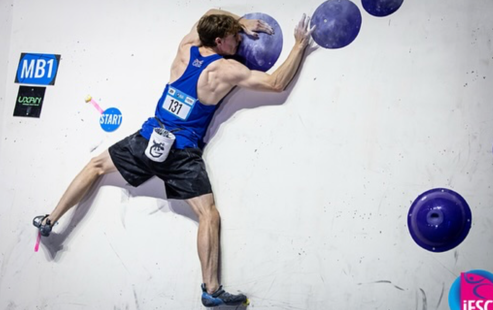 Climber Sam Butterworth competing in a bouldering final
