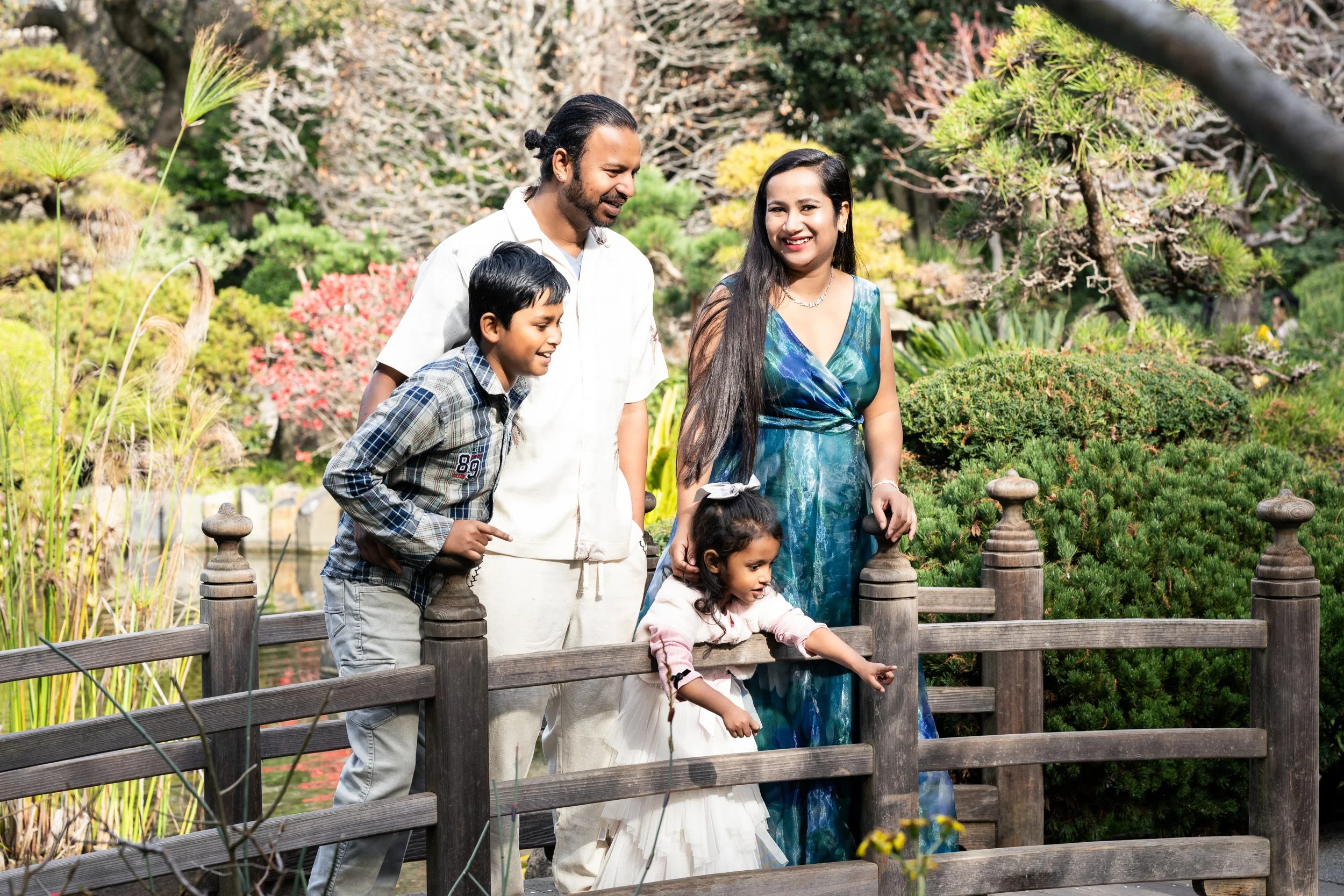 Family on wooden bridge at San Mateo Japanese Garden