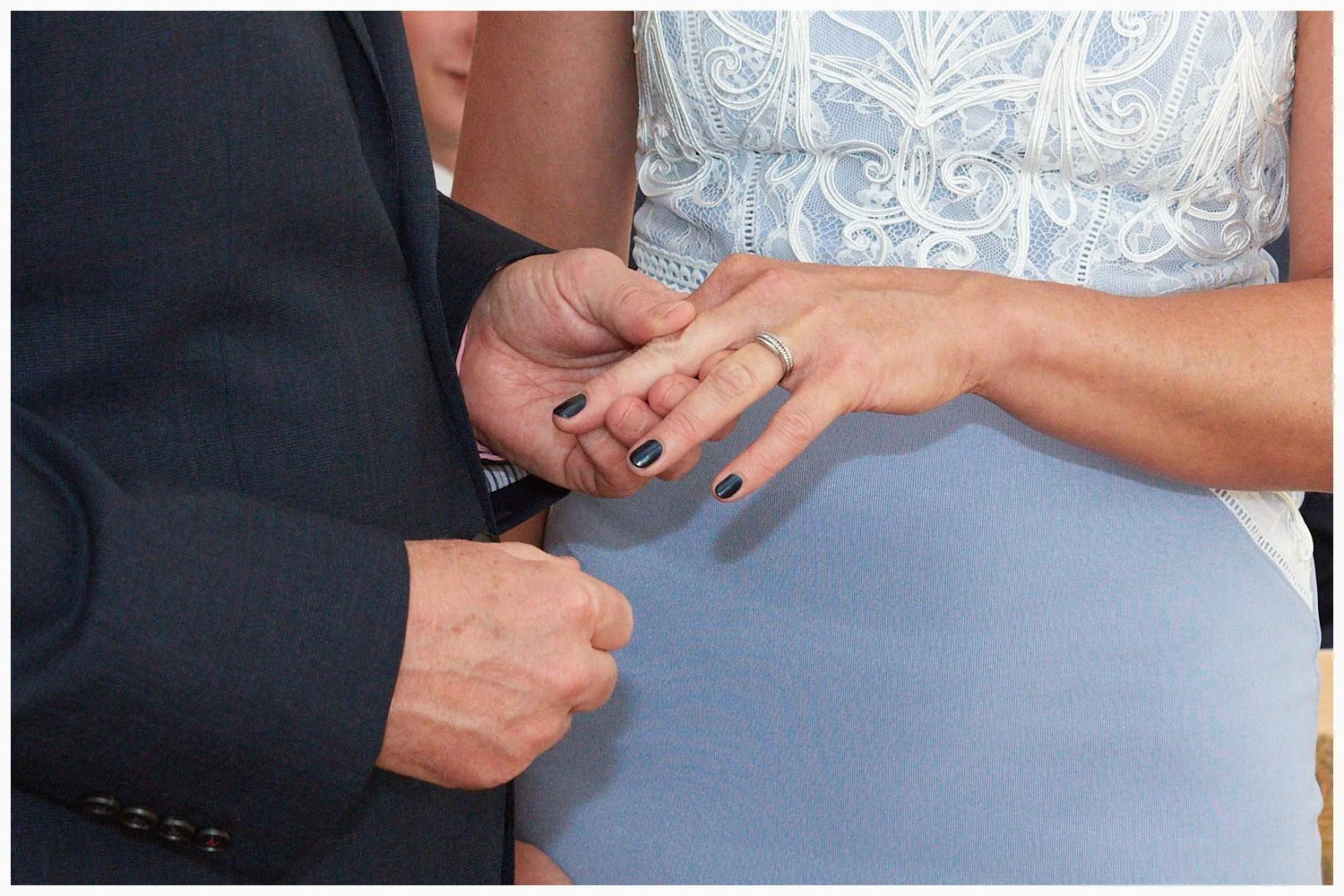 Bride and groom exchange wedding rings during the marriage ceremony
