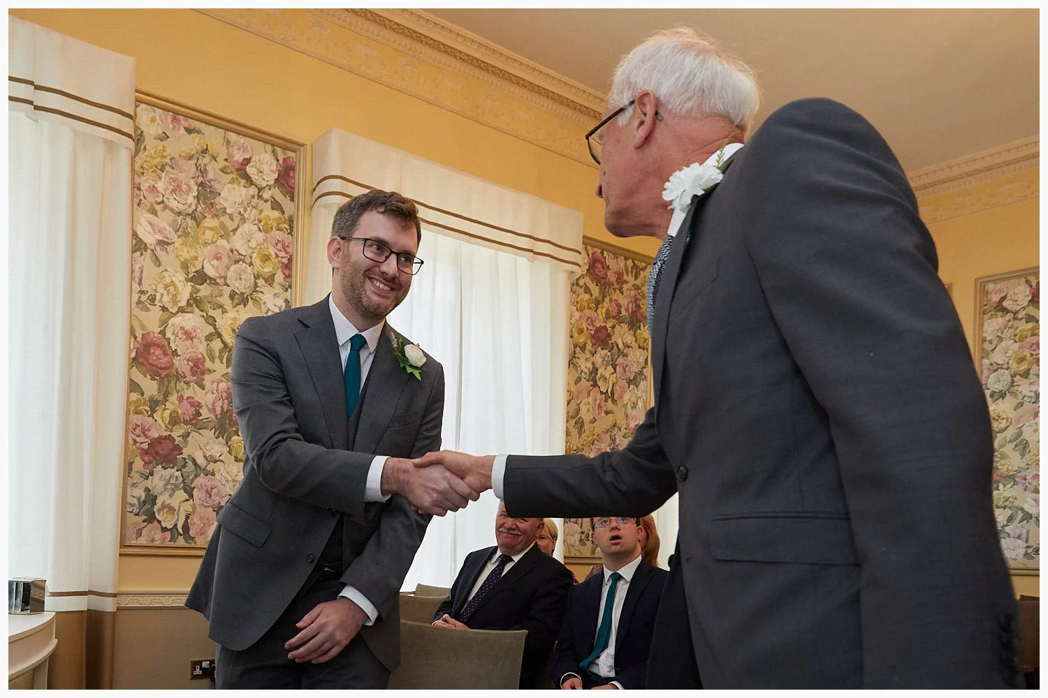Father of the bride shakes hands with his future son in law