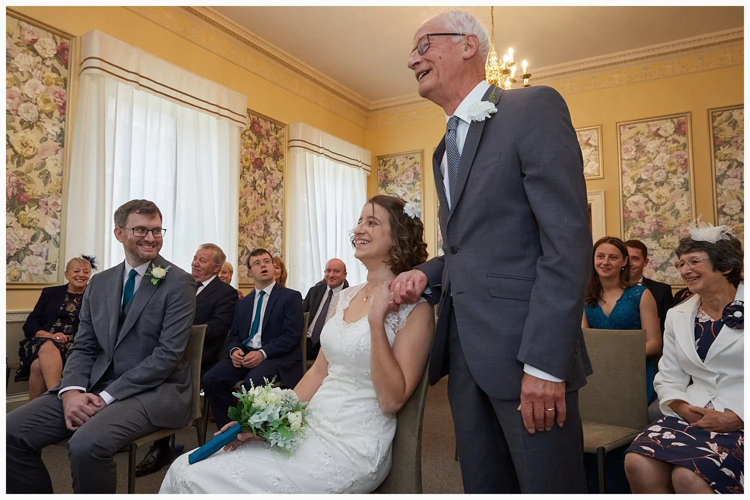 Father of the bride reassures his daughter at the start of her wedding ceremony