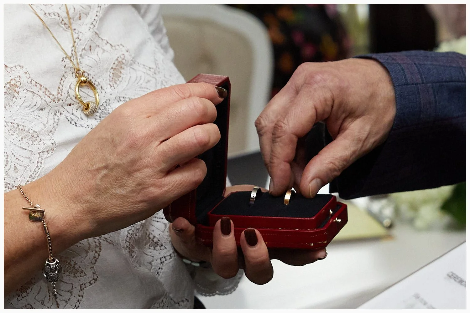 Bride and groom exchange wedding rings during their ceremony at Weybridge Registry Office