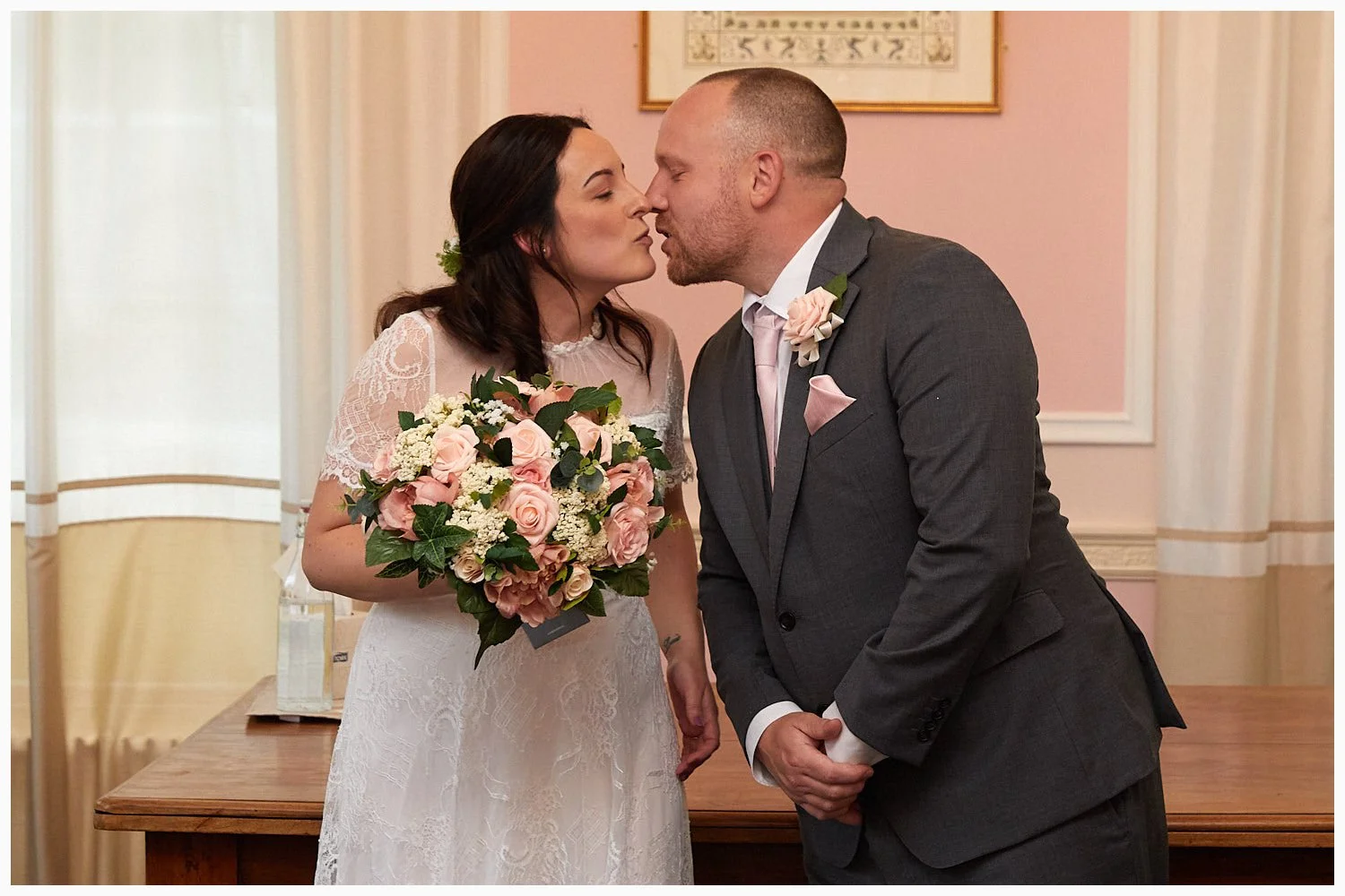 Bride and groom kiss at the end of their wedding ceremony