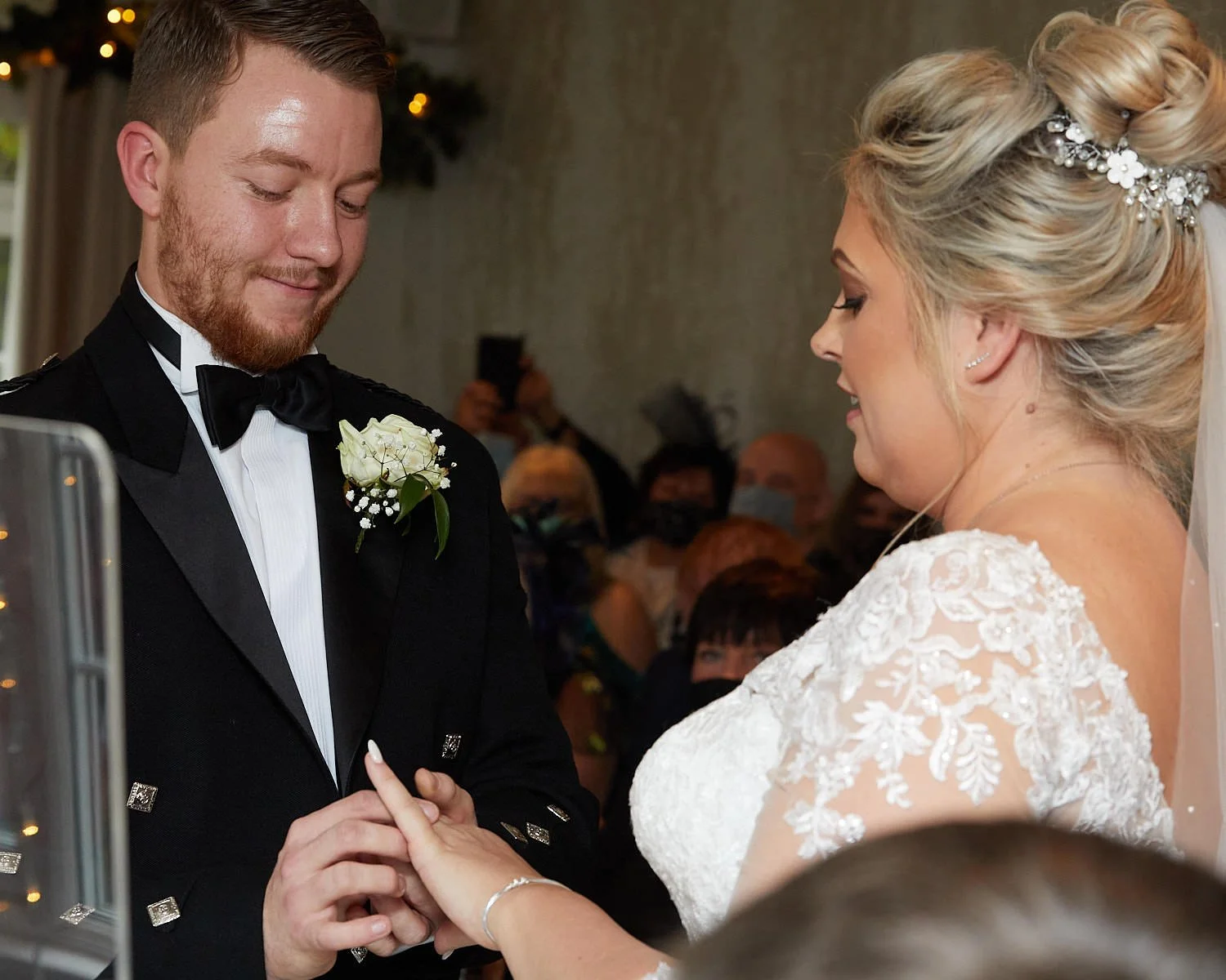 Bride and groom exchange their wedding rings during their ceremony at The Mill House Hotel Swallowfield