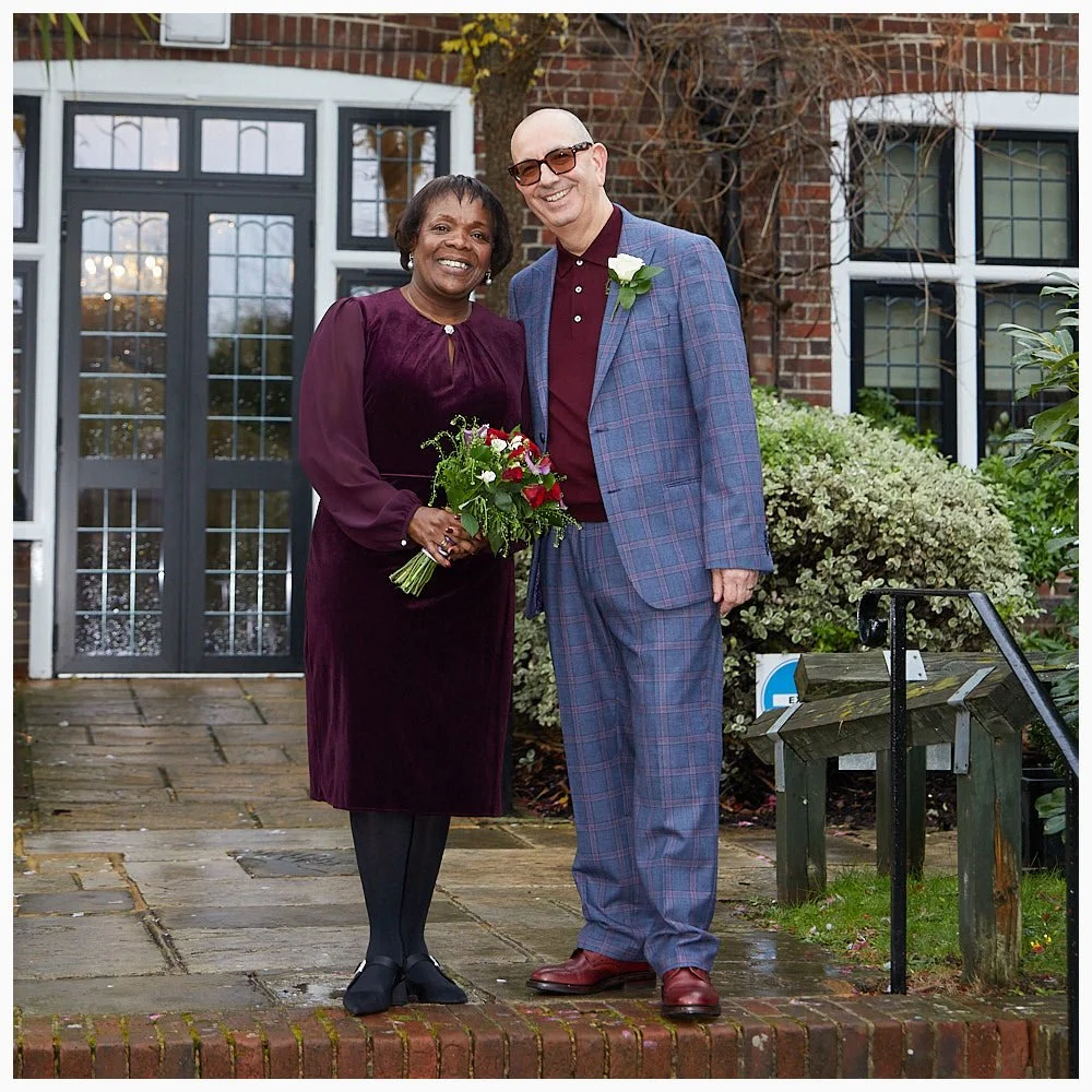 Bride and groom pose for photo in the gardens at Weybridge Registry Office after their marriage ceremony