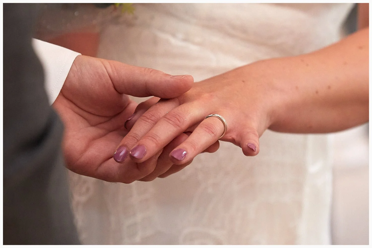 The exchange of wedding rings during the marriage ceremony in the Carnarvon Room at Basingstoke Registry Office