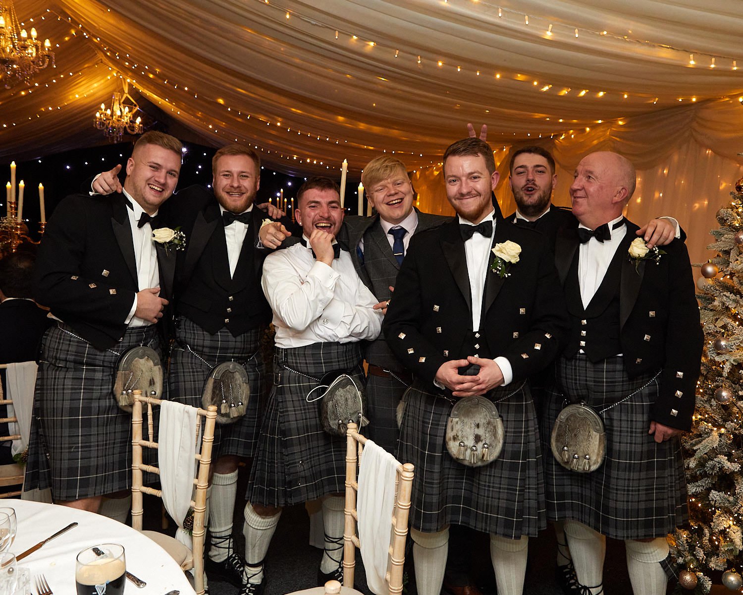Groom and his groomsmen pose for a fun group photo at the wedding reception at The Mill House Hotel Swallowfield
