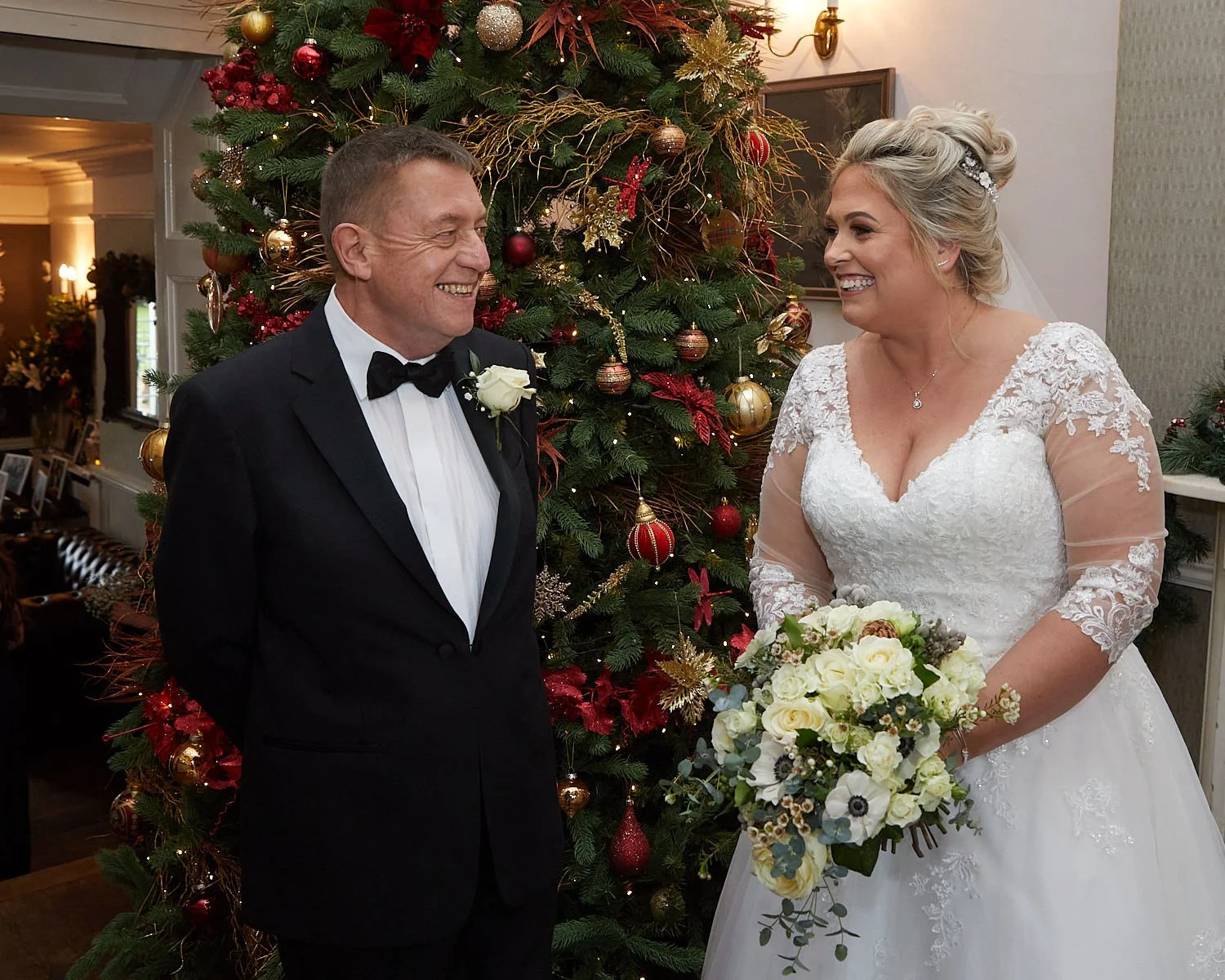 The Mill House Hotel Swallowfield near Reading, bride and her father in front of the Christmas tree before her wedding