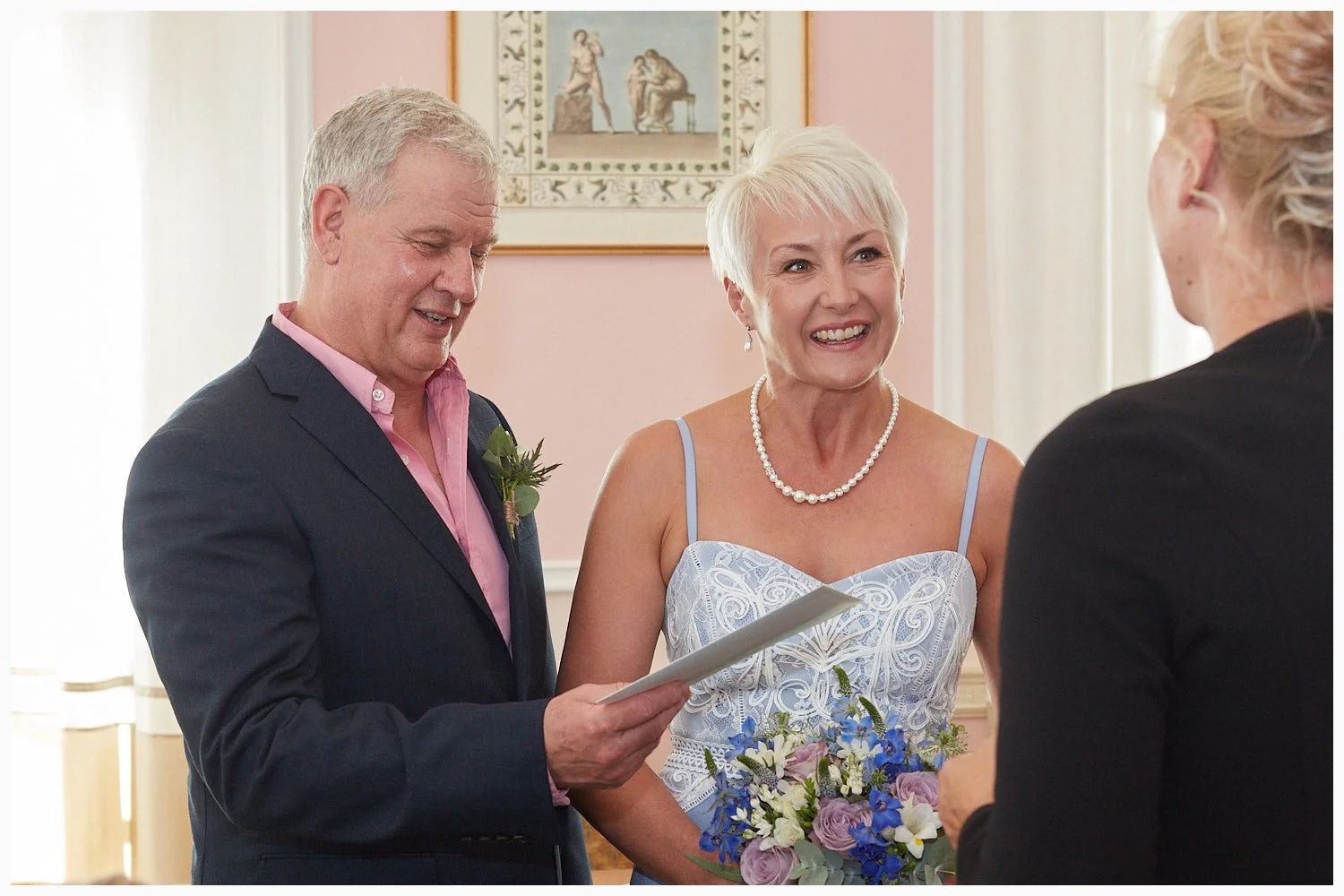 The registrar hands the bride and groom their marriage schedule after their wedding at Basingstoke Registry Office