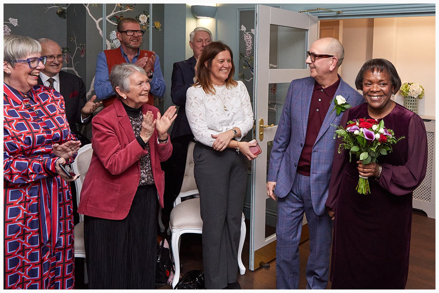 Guests greet the bride and groom as they enter for the wedding ceremony