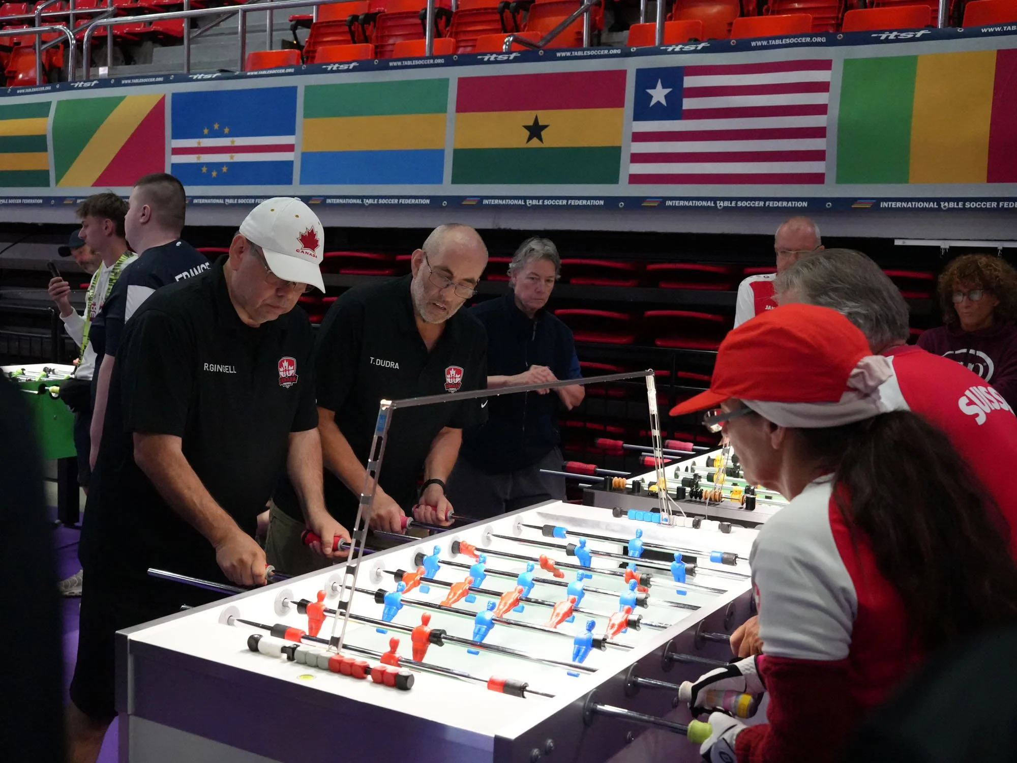 Robert Gingell (left) and Tim Dudra face Hansueli Kropf and François Rotzetter on Garlando as Canada defeats Switzerland in the Last‑16.