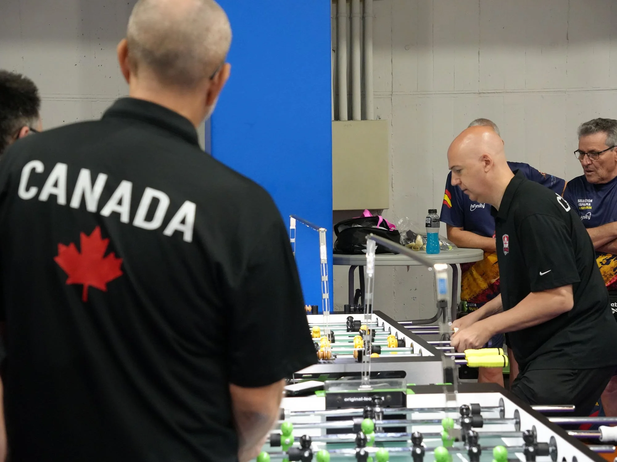 Tim Dudra watches as teammate Steve Dumont plays singles in World Cup action.