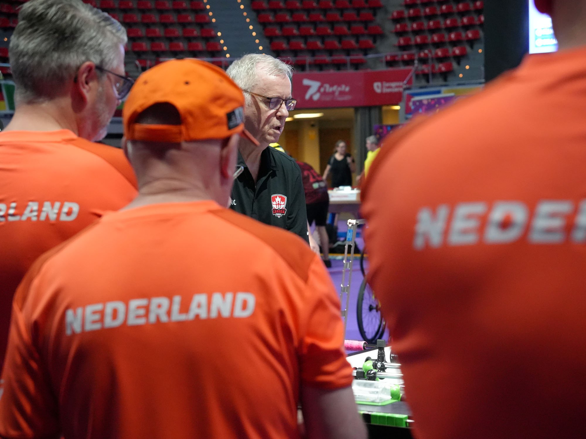 Dutch players watch as Richard Tench closes leg 3 with Canada ahead 30–14.