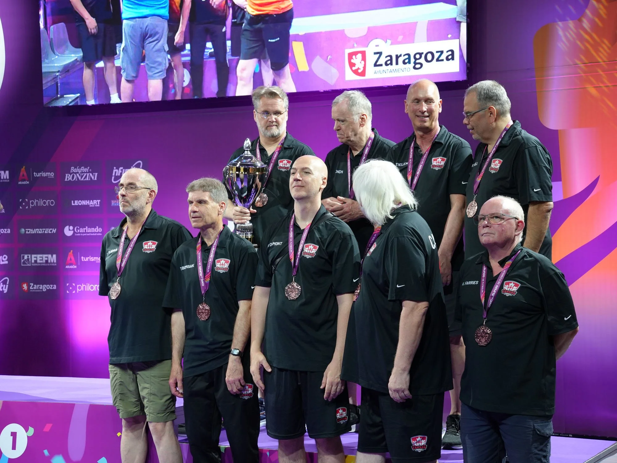 Bronze‑medal Seniors World Cup winners: front row Tim Dudra, Taras Bombak, Steve Dumont, Gerry Meister, Kent Farries; back row Eric Dunn, Richard Tench, Peter Tielens, Robert Gingell.