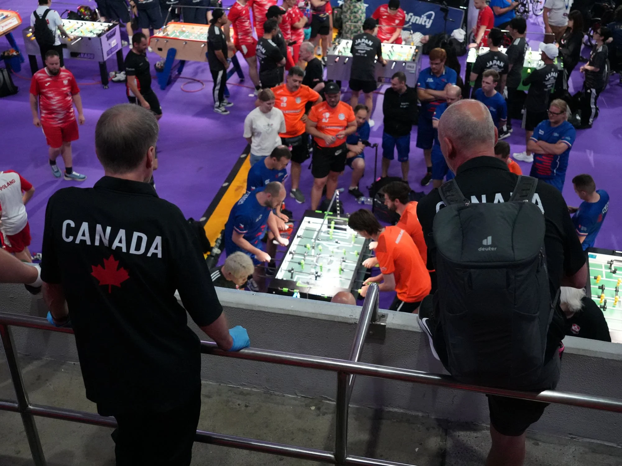 Taras Bombak (left) and Peter Tielens watch the Canada–Japan match.