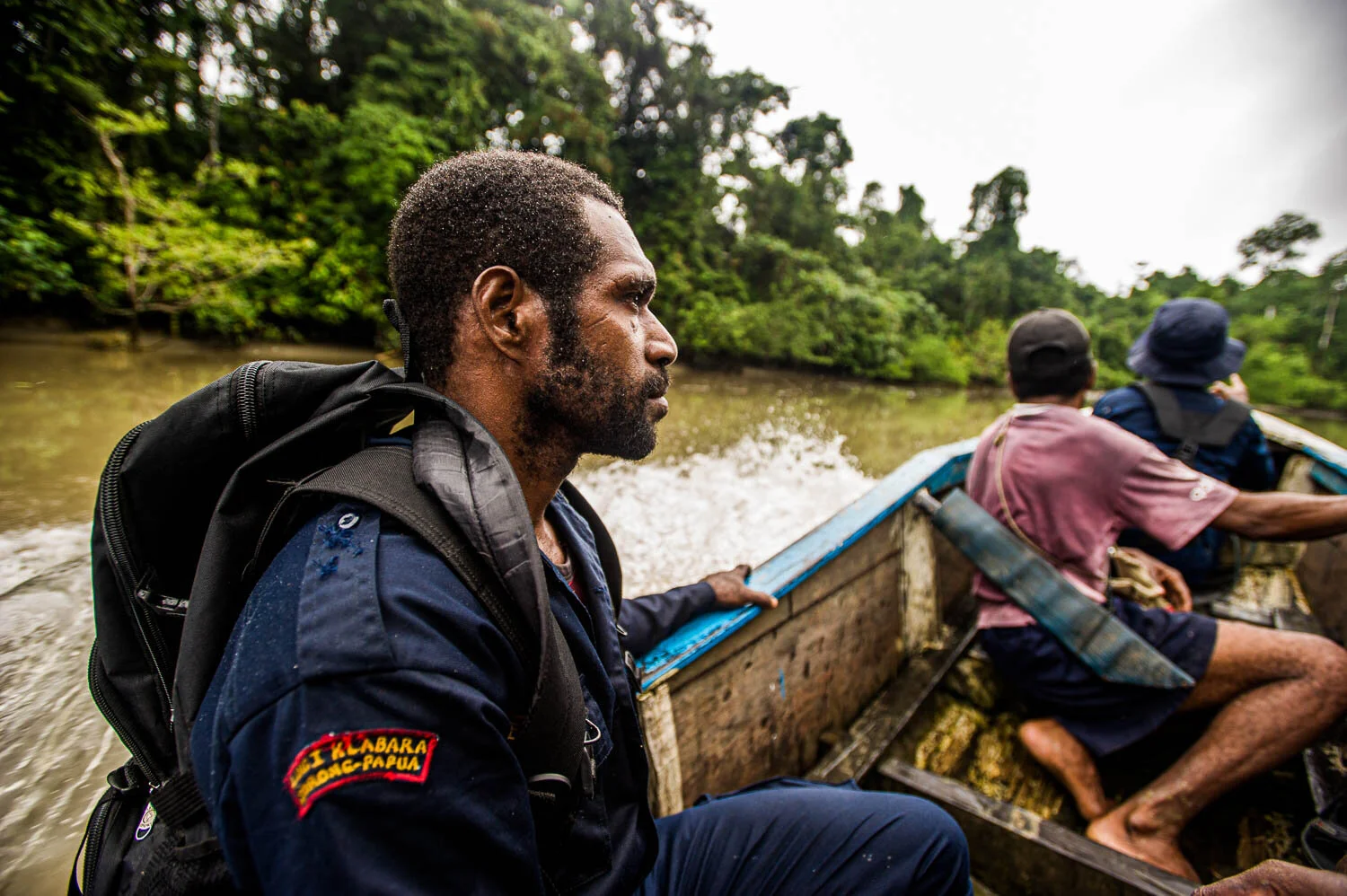 There is an alternative government in West Papua called the Traditional People's Council, with their own police force, citing human rights and environmental issues as their top priority. Here a member of the traditional police is patrolling by river.