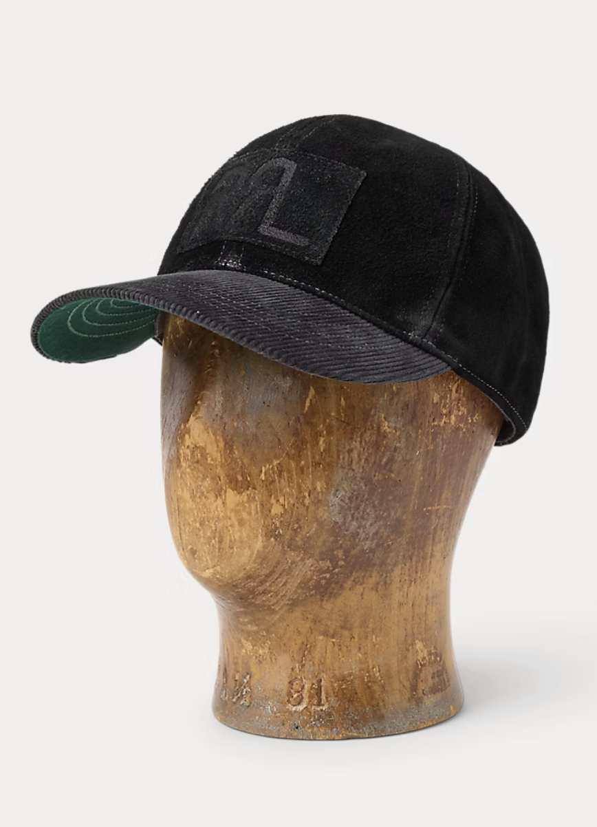 Black baseball cap with a curved brim and a Velcro strap, displayed on a wooden mannequin head