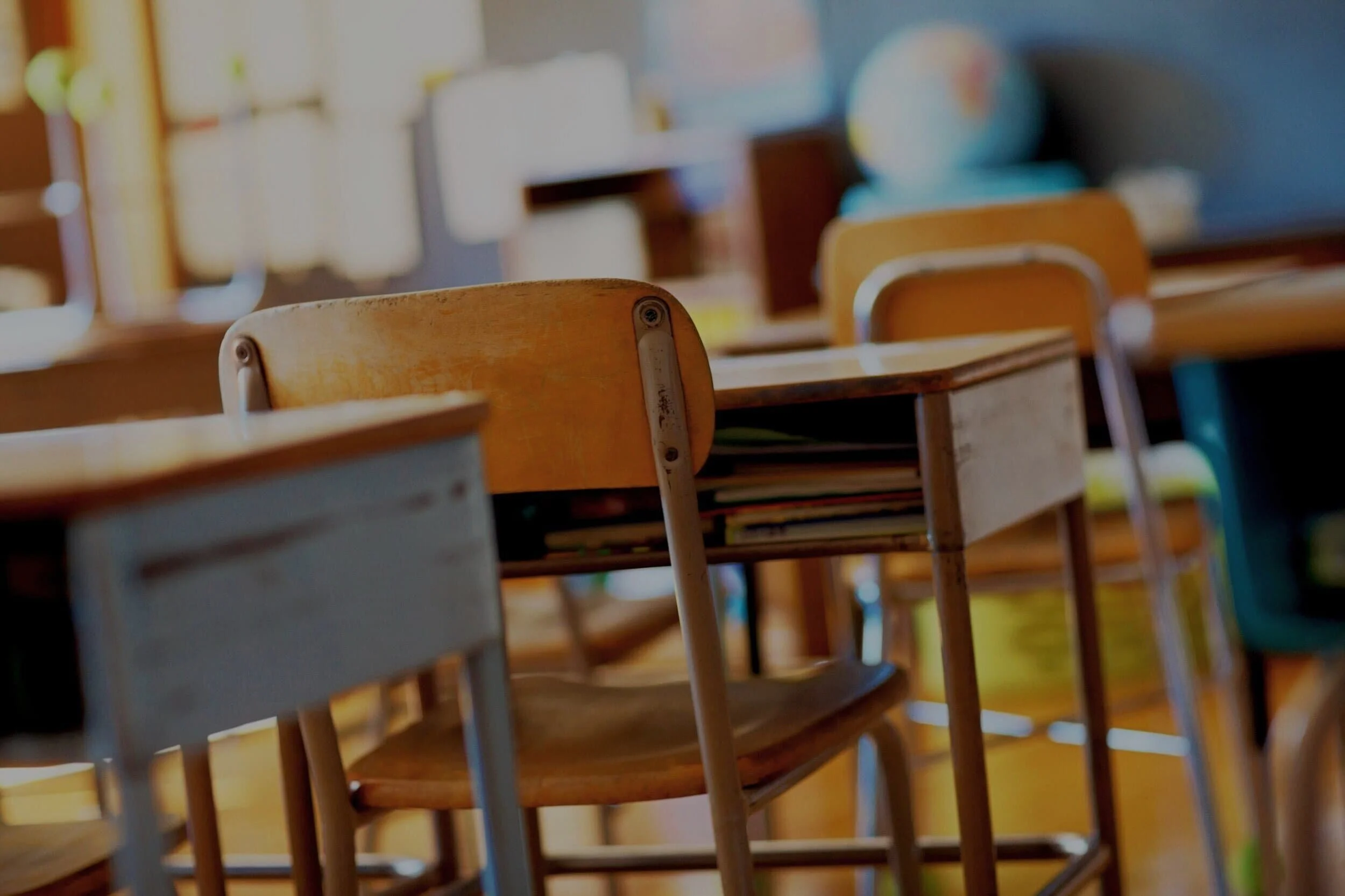 Close up of a row of desks in a classroom
