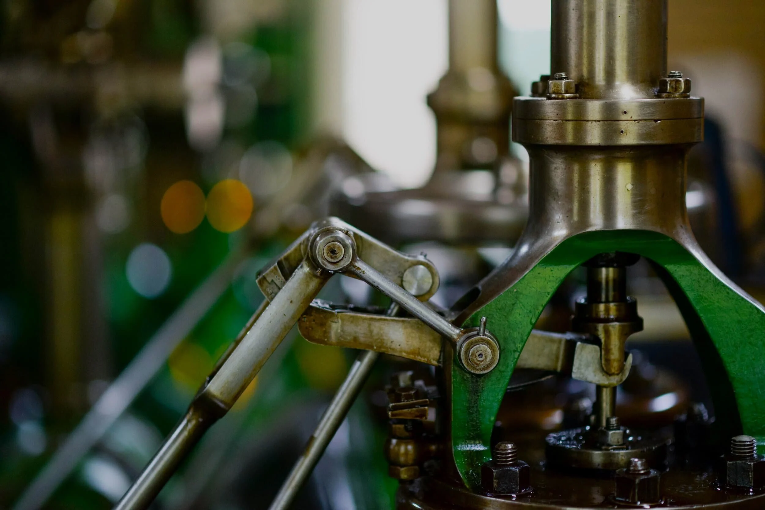Close up of the parts of a green manufacturing machine