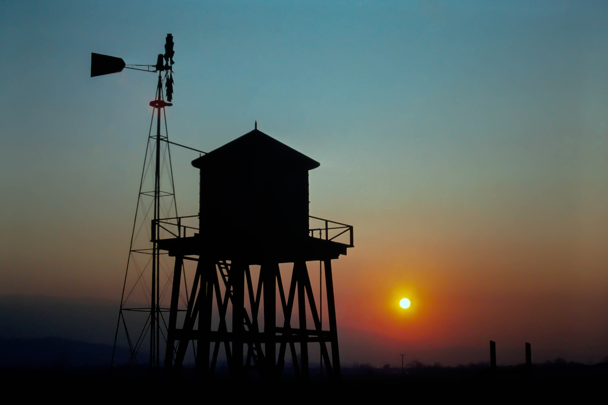 Old windmill and water tower at sunset, South San Jose, California.