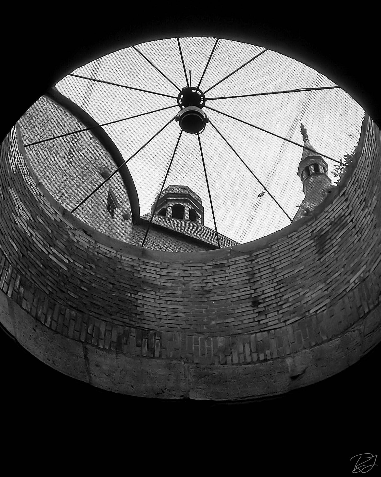 Looking up through a tunnel vent to the street and sky, Nancy, France.