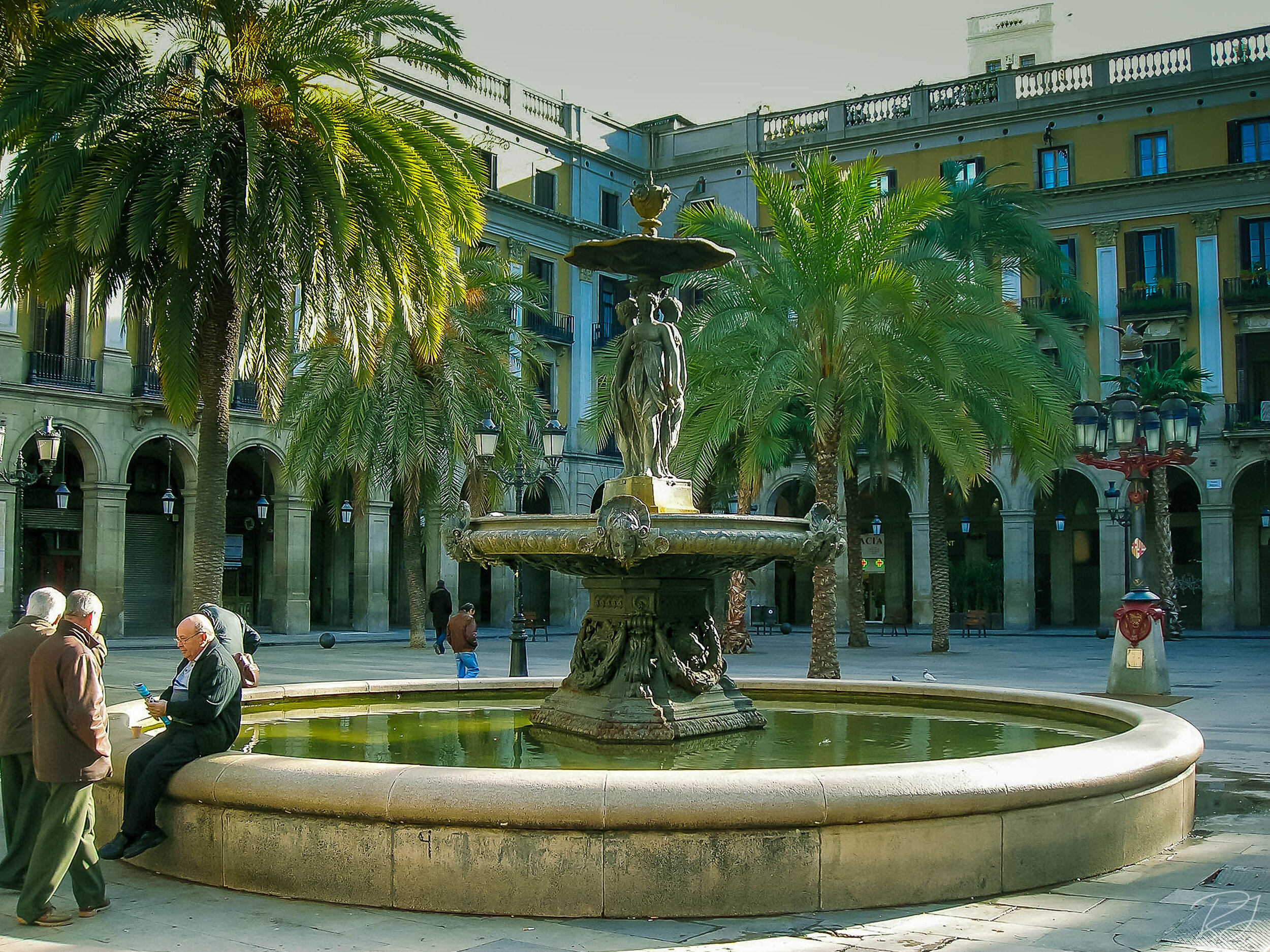 Plaza Real with fountain and Gaudi's lamp in Barcelona, Spain.