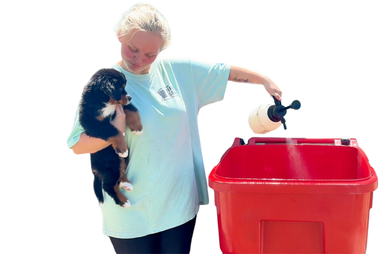 An employee of The Bin Spa deodorizing a trash can to make it smell great and repell maggots.