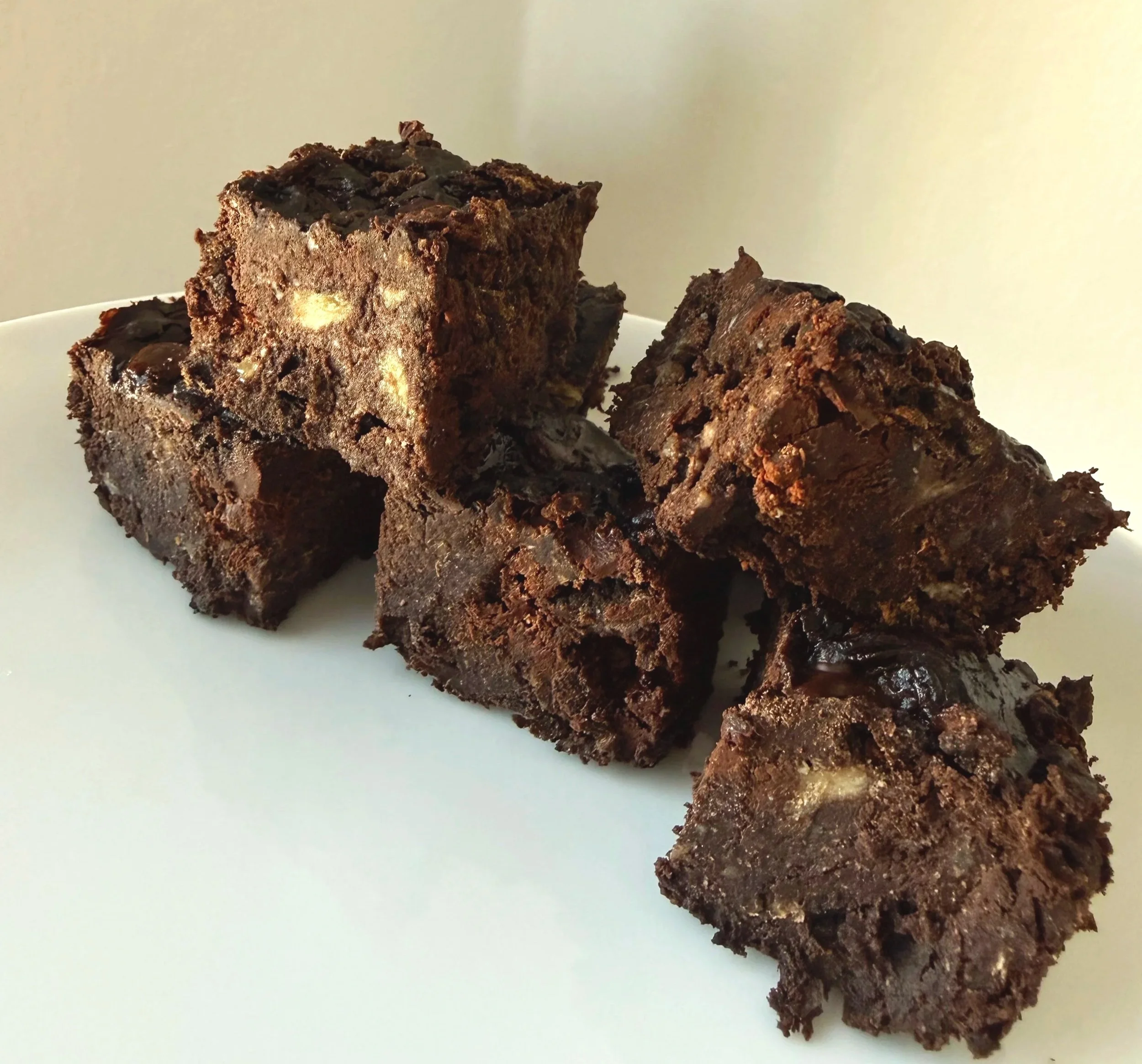Fudgy healthy banana brownies made with chocolate protein powder and peanut butter, with dark chocolate chips mixed in