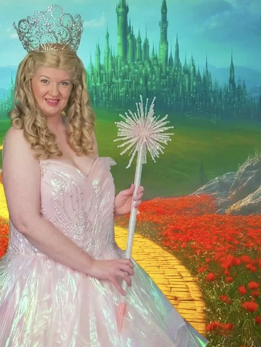 Bubble Witch party princess in pink bubble gown holding her magic wand with emerald city backdrop behind her