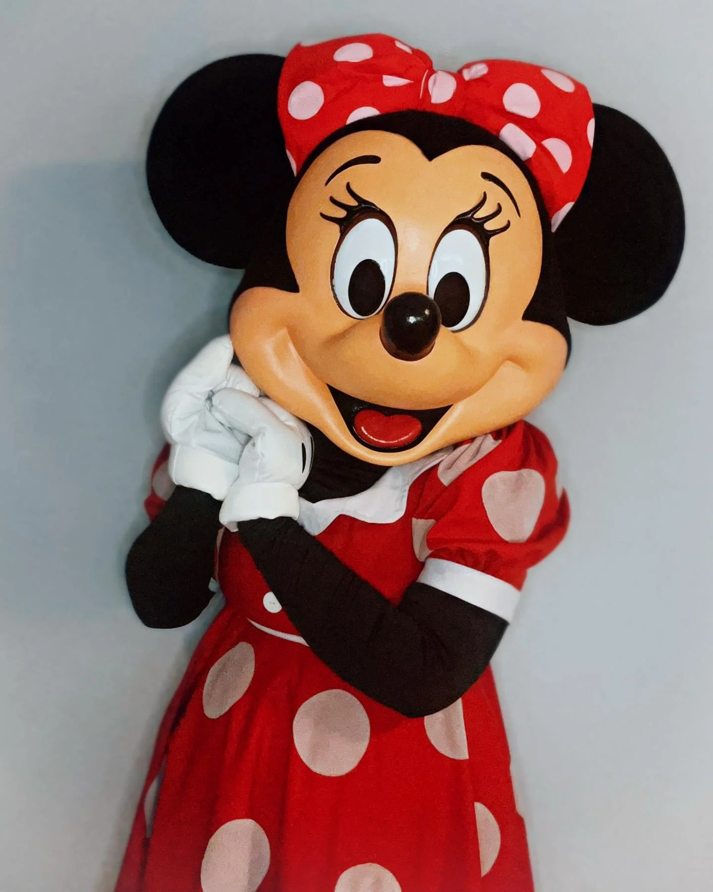 Miss Mouse party character with a red polka dot dress, red bow, and white gloves.