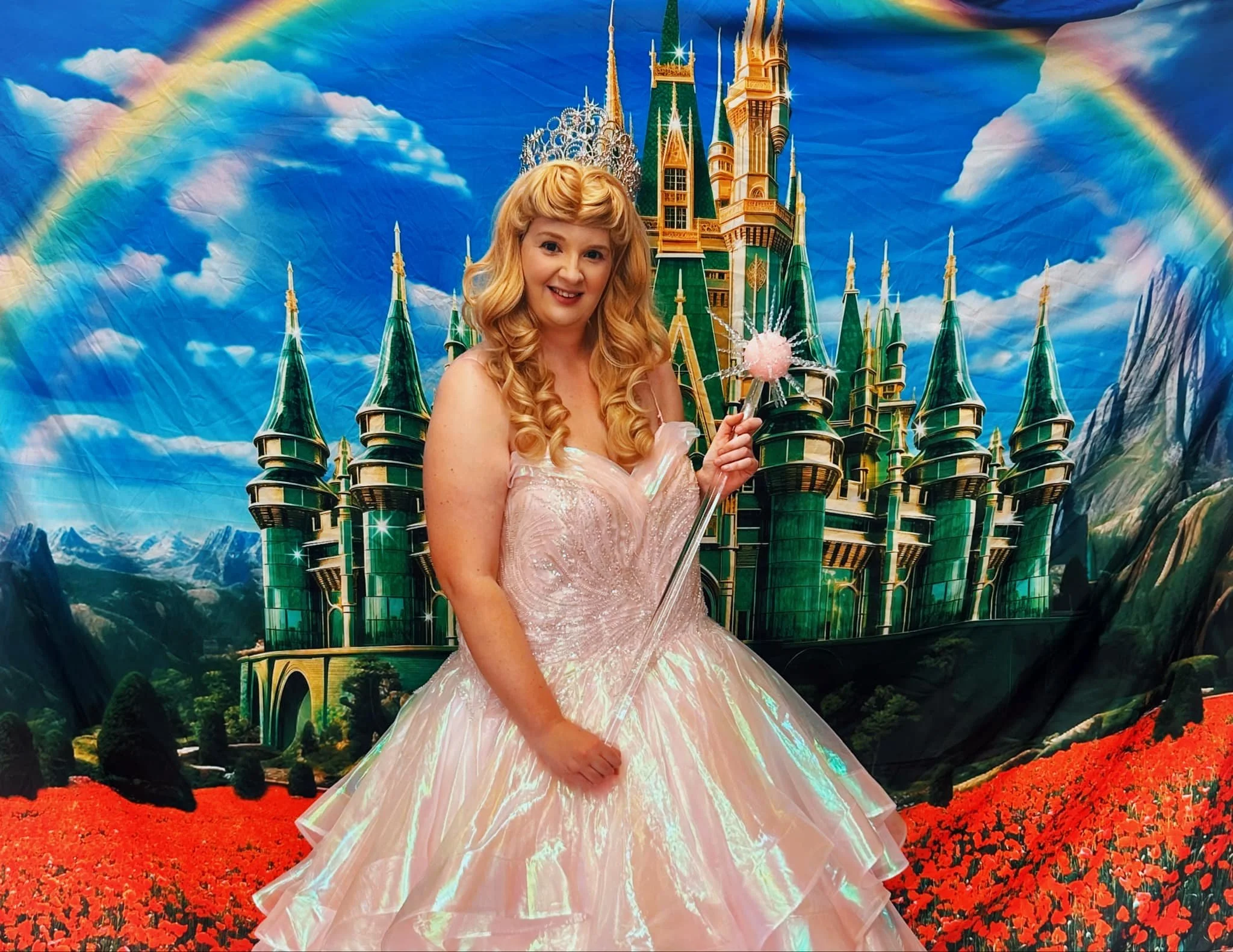 Bubble Witch party princess in pink bubble gown holding her magic wand with emerald city backdrop behind her