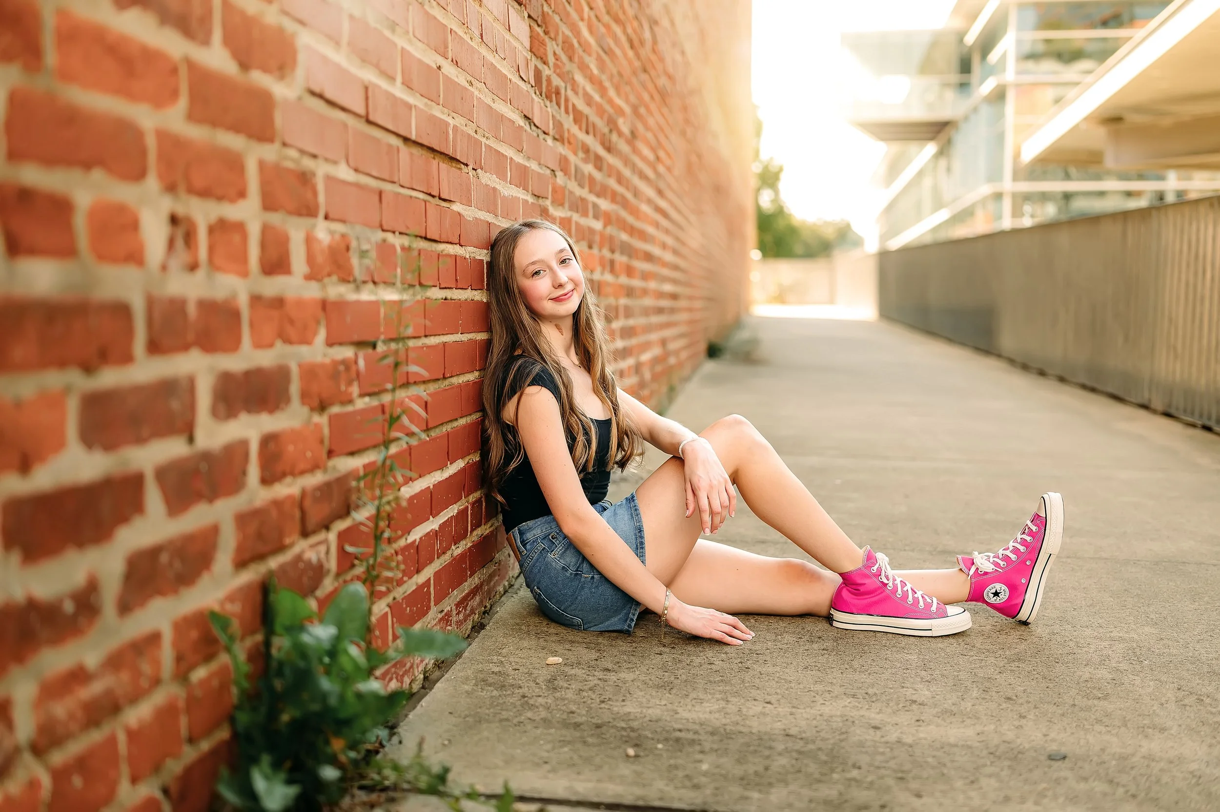 high school senior photoshoot urban vibes, downtown, brick walls and converse