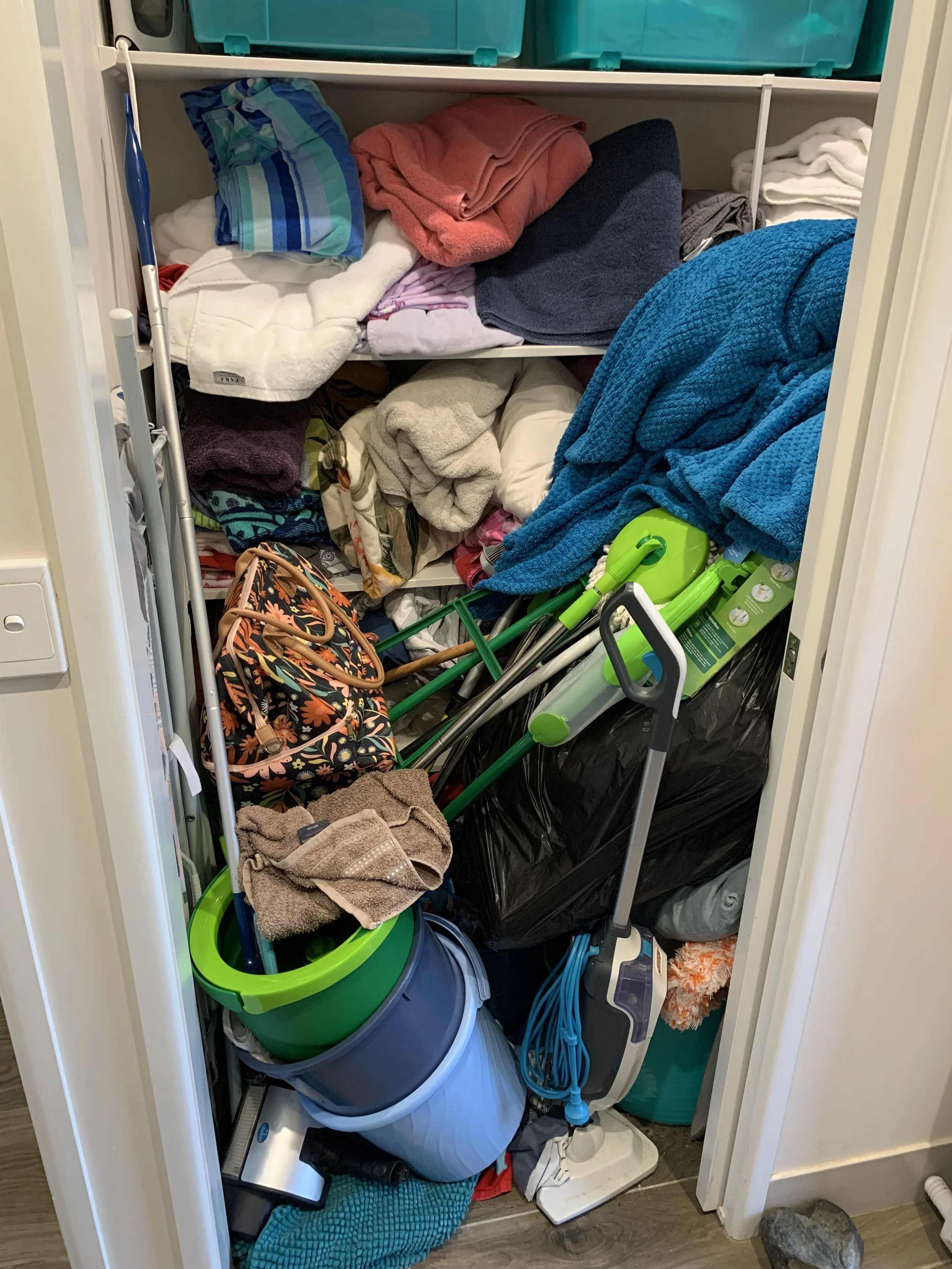 Cluttered laundry cupboard 