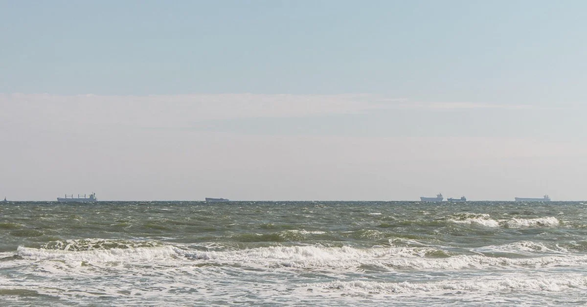 Merchant vessels navigating at distance in the northern Black Sea. Credit: Nataliia Shcherbyna, Alamy
