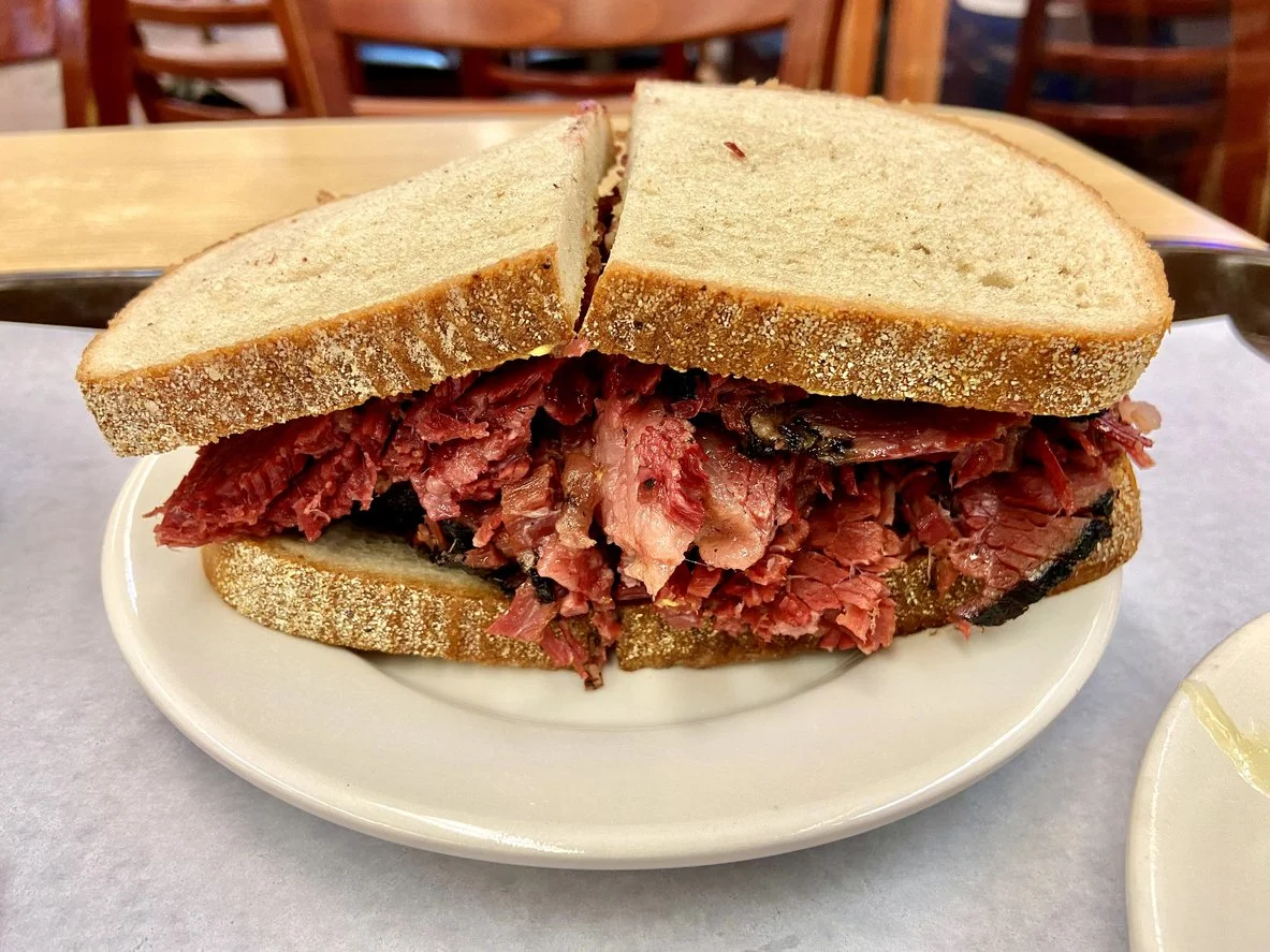 Pastrami sandwich on a white plate