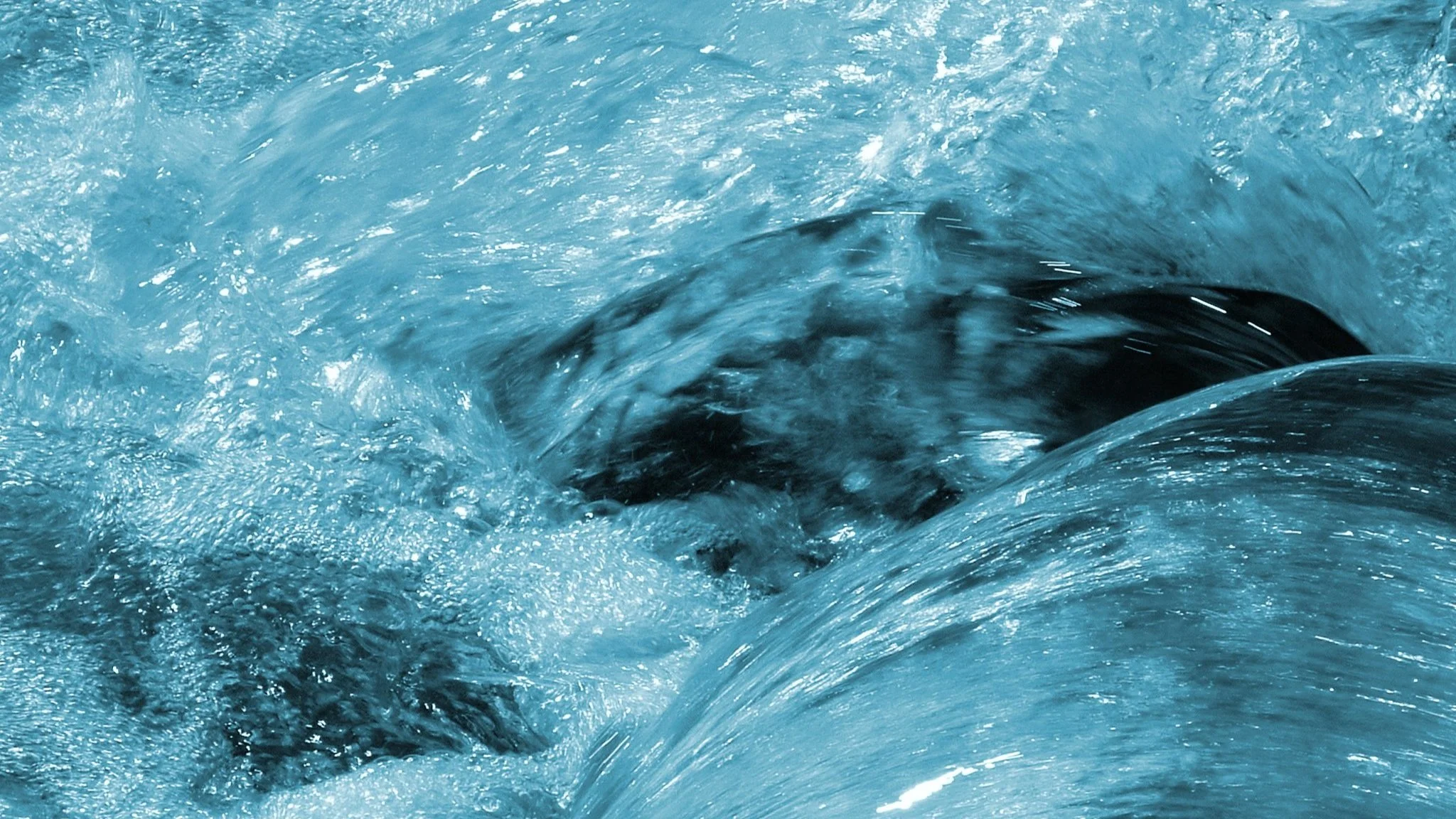 Rushing river water background. Blue toned.