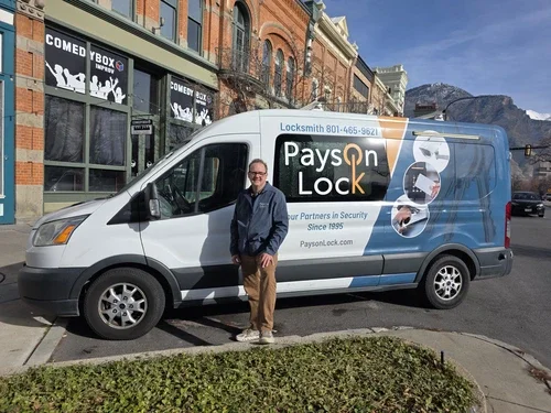 Locksmith standing by a Payson Lock & Key vehicle in Provo, Utah.