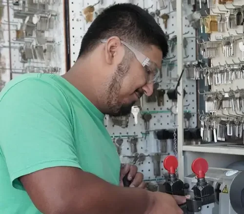 Payson Lock & Key locksmith cutting a car key copy in Payson, Utah.