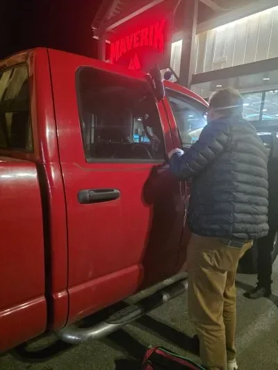 Payson Lock technician opening a truck at Maverik in Nephi at night.