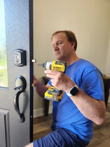 Provo locksmith installing door hardware on a home.
