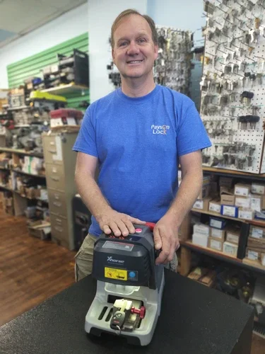 Payson Lock locksmith technician standing with transponder key machine.