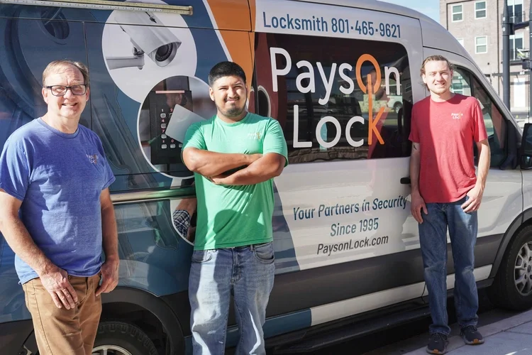 Three locksmith technicians standing by a Payson Lock & Key service van in Provo, Utah.