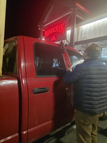Payson Lock & Key locksmith opening a locked truck at night near Maverik in Nephi, Utah.