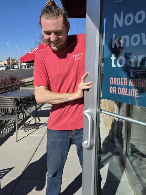 Provo locksmith installing door hardware on a business.